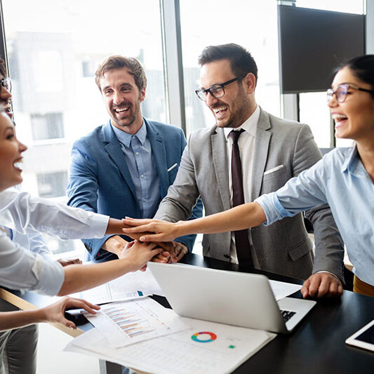 Business team celebrating a good job in the modern office